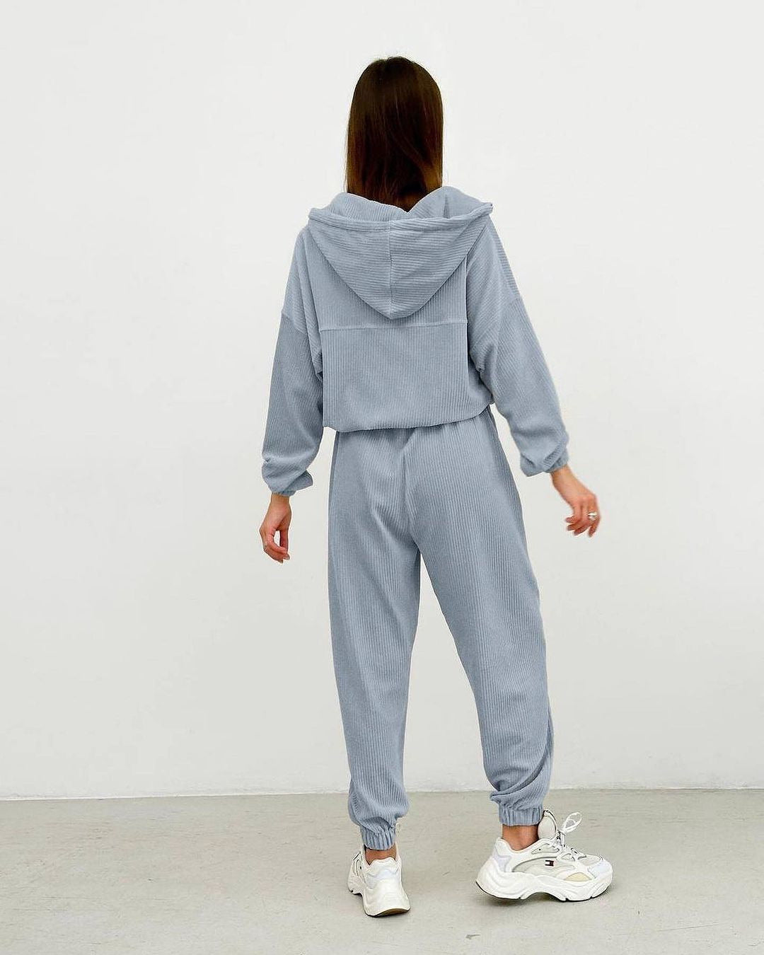 "Ensemble minimaliste femme : veste zippée à capuche et pantalon."